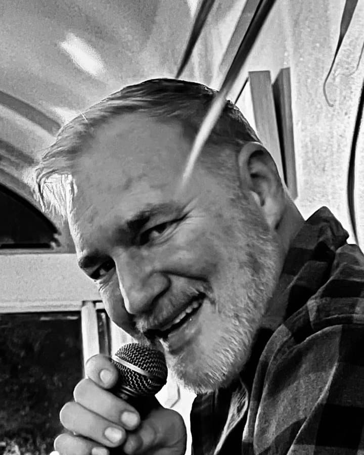 Michael Childs smiling into a microphone